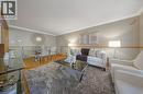 Open-concept living space featuring wood-finish flooring, crown molding, and a neutral color palette - 124 Dunsmere Drive, Kitchener, ON  - Indoor Photo Showing Living Room 