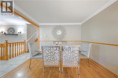 Hardwood flooring paired with light gray walls and white crown molding - 124 Dunsmere Drive, Kitchener, ON - Indoor Photo Showing Other Room
