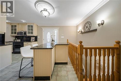Kitchen island with a dark countertop and beadboard paneling - 124 Dunsmere Drive, Kitchener, ON - Indoor Photo Showing Other Room