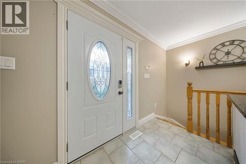 Entryway featuring a white front door with an oval leaded glass insert, complemented by a sidelight with matching leaded glass - 124 Dunsmere Drive, Kitchener, ON - Indoor Photo Showing Other Room