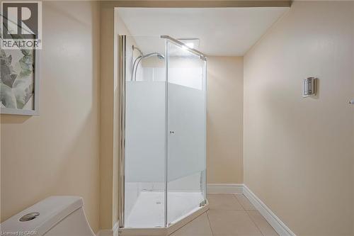 Corner shower with frosted glass enclosure, white tile base, and chrome fixtures - 124 Dunsmere Drive, Kitchener, ON - Indoor Photo Showing Bathroom