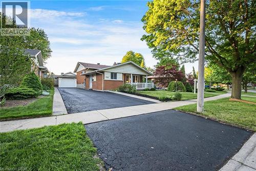 Brick and siding ranch-style exterior with an attached single-car garage and a paved driveway - 124 Dunsmere Drive, Kitchener, ON - Outdoor