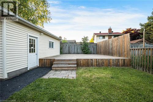 Expansive wood-finish deck with multiple steps and a privacy screen - 124 Dunsmere Drive, Kitchener, ON - Outdoor With Deck Patio Veranda With Exterior