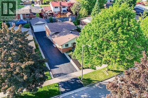 Aerial perspective highlighting a residential property with a detached garage and a long asphalt driveway - 124 Dunsmere Drive, Kitchener, ON - Outdoor