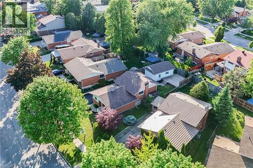 Neighborhood featuring mature trees, residential properties with brick and siding exteriors, varied rooflines, and private backyards with fencing - 124 Dunsmere Drive, Kitchener, ON - Outdoor With View