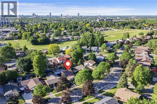 Aerial perspective showcasing a residential neighborhood with ample mature trees and green spaces - 124 Dunsmere Drive, Kitchener, ON - Outdoor With View