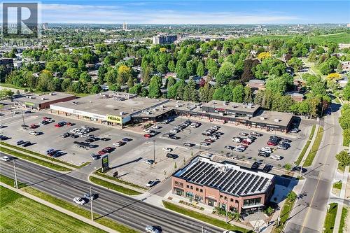 Retail plaza featuring multiple storefronts, extensive surface parking, and direct frontage on a multi-lane road - 124 Dunsmere Drive, Kitchener, ON - Outdoor With View