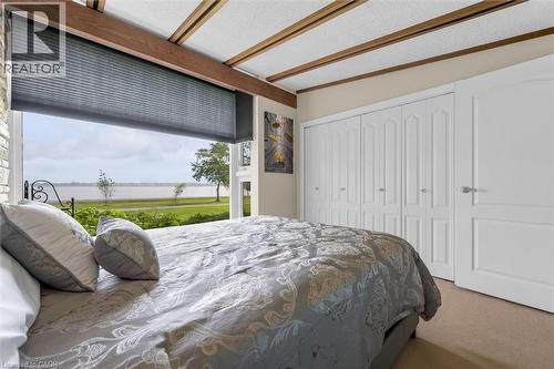 Expansive window overlooking a body of water with a grassy shoreline - 899 Niagara Parkway, Fort Erie, ON 