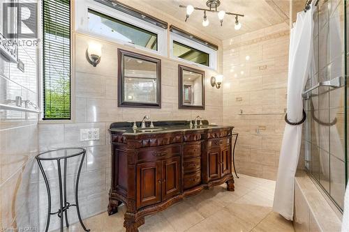 Ornate double vanity with dark wood cabinetry and dual sinks - 899 Niagara Parkway, Fort Erie, ON 