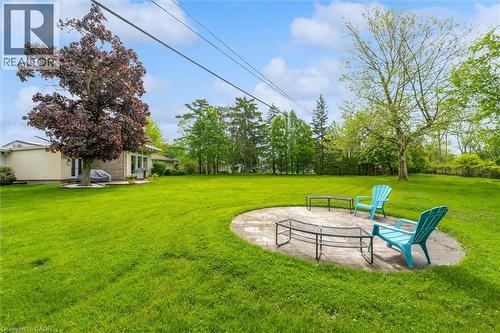 Expansive green lawn with a circular stone patio - 899 Niagara Parkway, Fort Erie, ON 