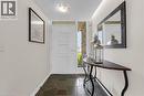 Entryway featuring natural slate tile flooring, a modern white door with frosted glass sidelight, stone exterior accents, and a flush-mount ceiling light fixture - 899 Niagara Parkway, Fort Erie, ON 