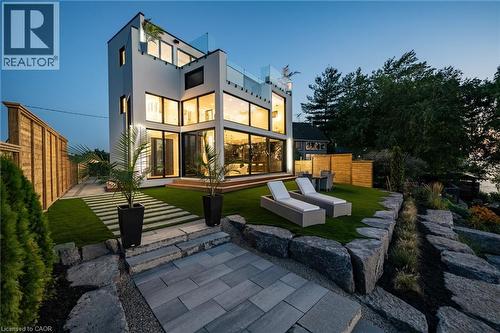 Modern architectural residence featuring multiple levels of glass balconies and expansive windows - 6 Firelane 11A Street, Niagara-On-The-Lake, ON - Outdoor With Deck Patio Veranda