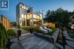 Modern architectural residence featuring multiple levels of glass balconies and expansive windows - 