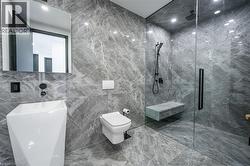 Contemporary bathroom featuring full-height stone-finish tiling - 