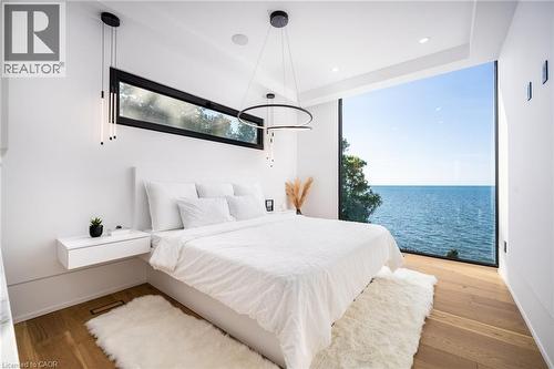 Expansive floor-to-ceiling window showcasing water scenery - 6 Firelane 11A Street, Niagara-On-The-Lake, ON - Indoor Photo Showing Bedroom