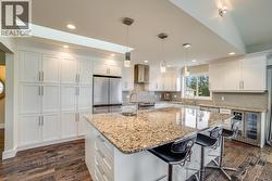 Bright Chef’s Kitchen With Oversized Island And Stainless Steel Appliances - 