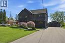 Dark-toned multi-story exterior with a gabled roofline - 71 Miles Road, Hamilton, ON 