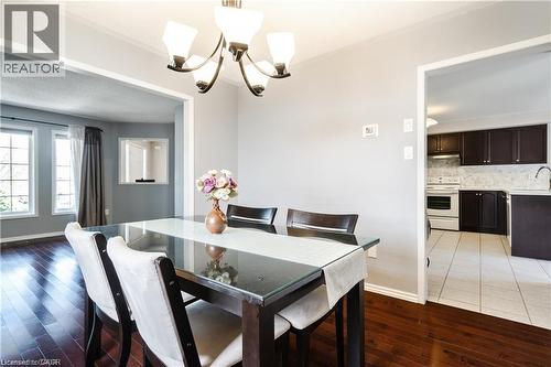 Dining area featuring a chandelier and wood-finish flooring - 106 Moore Crescent, Ancaster, ON 