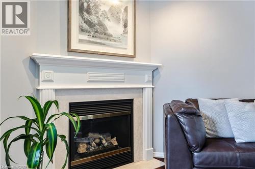 Fireplace with a decorative white mantelpiece and detailed architectural trim - 106 Moore Crescent, Ancaster, ON 