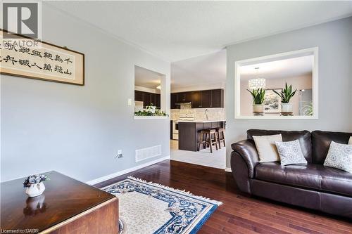 Interior space featuring wood-finish flooring, light grey walls, and white trim - 106 Moore Crescent, Ancaster, ON 