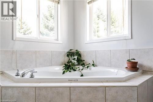 Integrated corner bathtub featuring chrome fixtures - 106 Moore Crescent, Ancaster, ON 