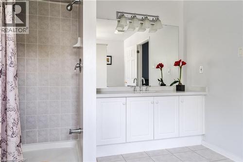 Bathroom vanity featuring a white countertop, under-mount sink, and chrome faucet - 106 Moore Crescent, Ancaster, ON 