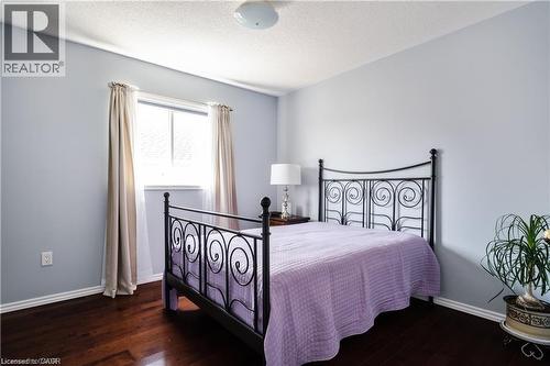Light blue walls complement the dark wood-finish flooring in this room - 106 Moore Crescent, Ancaster, ON 
