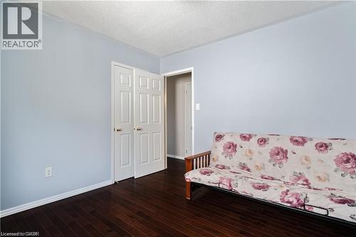 Room featuring dark wood-finish flooring and light-toned walls - 106 Moore Crescent, Ancaster, ON 