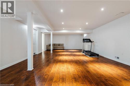 Spacious lower level featuring wood-finish flooring, recessed lighting, white walls, and bright white trim - 106 Moore Crescent, Ancaster, ON 