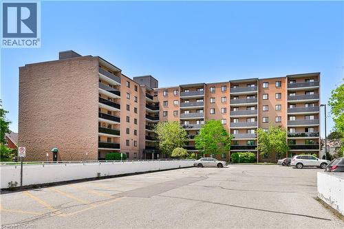 Multi-story residential building featuring a brick exterior and private balconies - 29 West Avenue, Kitchener, ON - Outdoor With Balcony With Facade