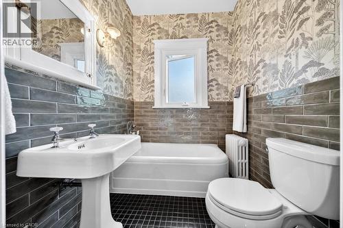 Pedestal sink with porcelain basin and chrome fixtures - 35 Burris Street, Hamilton, ON - Indoor Photo Showing Bathroom