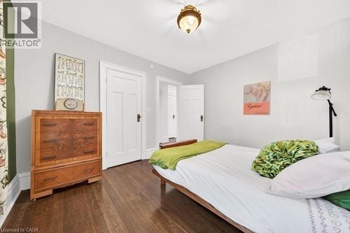 Hardwood flooring paired with light gray walls - 35 Burris Street, Hamilton, ON - Indoor Photo Showing Bedroom