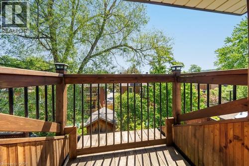 Expansive wood-finish deck featuring dark-toned railings and post cap lighting - 35 Burris Street, Hamilton, ON - Outdoor With Exterior