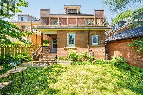 Brick exterior with a second-story balcony featuring wood railing - 35 Burris Street, Hamilton, ON - Outdoor