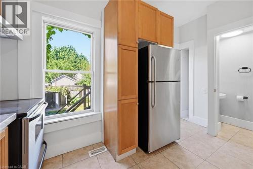 Kitchen featuring a stainless steel refrigerator, light wood-finish cabinetry - 343 Cumberland Avenue, Hamilton, ON 
