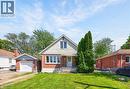 Brick residence featuring a gabled roofline, front-facing window dormer, and a covered porch entry - 43 West 1St Street, Hamilton, ON 