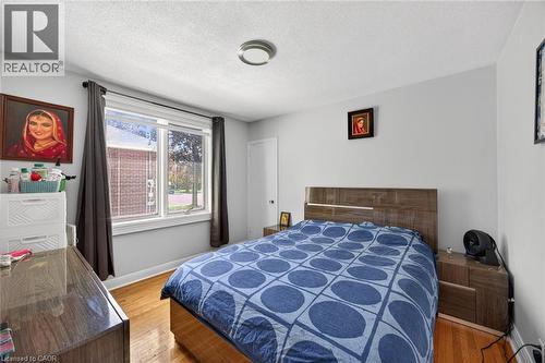 Bright room featuring light grey walls and wood-finish flooring - 43 West 1St Street, Hamilton, ON 