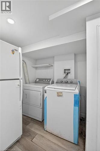 Utility area with wood-finish flooring, recessed lighting, and wall-mounted shelving - 43 West 1St Street, Hamilton, ON 