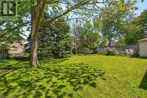 Expansive lawn area featuring mature trees providing natural shading - 43 West 1St Street, Hamilton, ON 