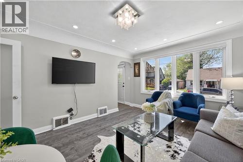 Living area featuring wood-finish flooring and light gray wall tones - 43 West 1St Street, Hamilton, ON 