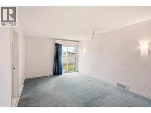 Main floor primary bedroom with ensuite and private patio. - 756 Springrose Way, Kelowna, BC 