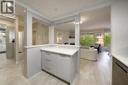 Open concept living - kitchen to living and dining room (digitally altered photos – leaves added) - 1960 Enterprise Way Unit# 412, Kelowna, BC - Indoor