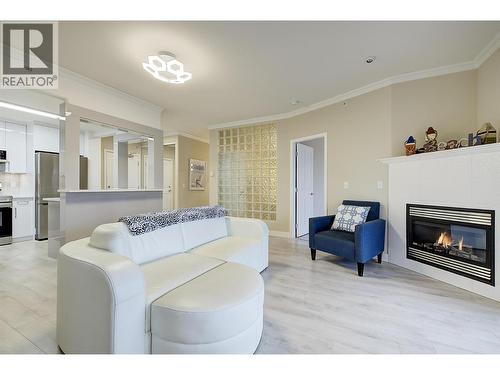 Bright living room with gas fireplace - 1960 Enterprise Way Unit# 412, Kelowna, BC - Indoor Photo Showing Living Room With Fireplace