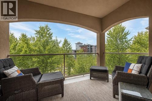 Spacious covered PRIVATE deck with beautiful views!  (digitally altered photos – leaves added) - 1960 Enterprise Way Unit# 412, Kelowna, BC - Outdoor With Deck Patio Veranda With Exterior