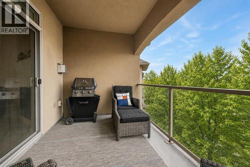Spacious covered PRIVATE deck with beautiful views! (digitally altered photos – leaves added) - 1960 Enterprise Way Unit# 412, Kelowna, BC - Outdoor With Exterior