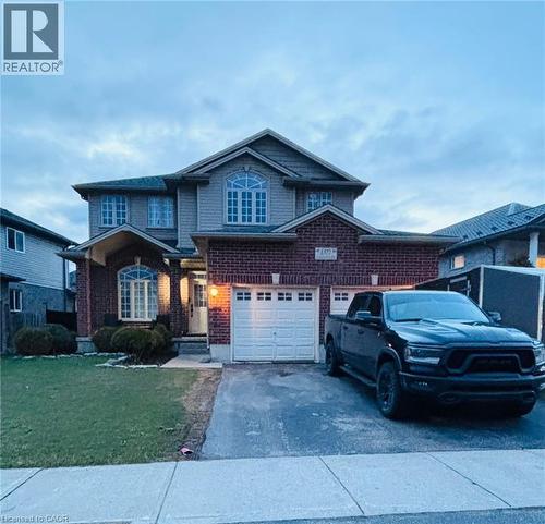 Brick and siding exterior featuring an arched entryway and multiple pane windows - 1377 Coronation Drive, London, ON - Outdoor With Facade