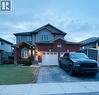 Brick and siding exterior featuring an arched entryway and multiple pane windows - 1377 Coronation Drive, London, ON  - Outdoor With Facade 