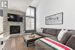 Family room anchored by gas fireplace. - 