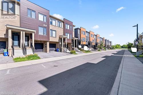 Modern townhome row featuring brick and panel siding - 40 Radison Lane, Hamilton, ON - Outdoor With Facade