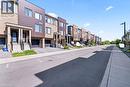 Modern townhome row featuring brick and panel siding - 40 Radison Lane, Hamilton, ON  - Outdoor With Facade 